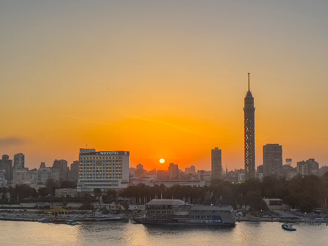 Sunset over the Cairo Tower from the east side of the Nile River, Cairo, Egypt, North Africa, Africa\n