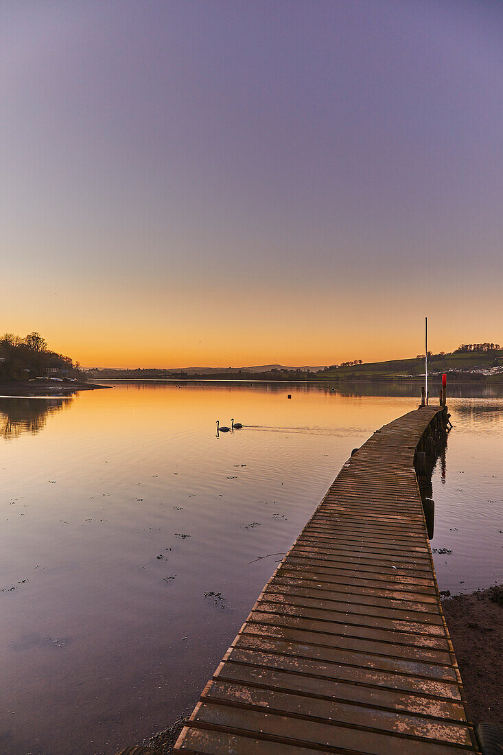 A very calm dusk scene, with a wooden jetty on the estuary of the River Teign, at Coombe Cellars, near Newton Abbot, south coast of Devon, England, United Kingdom, Europe\n