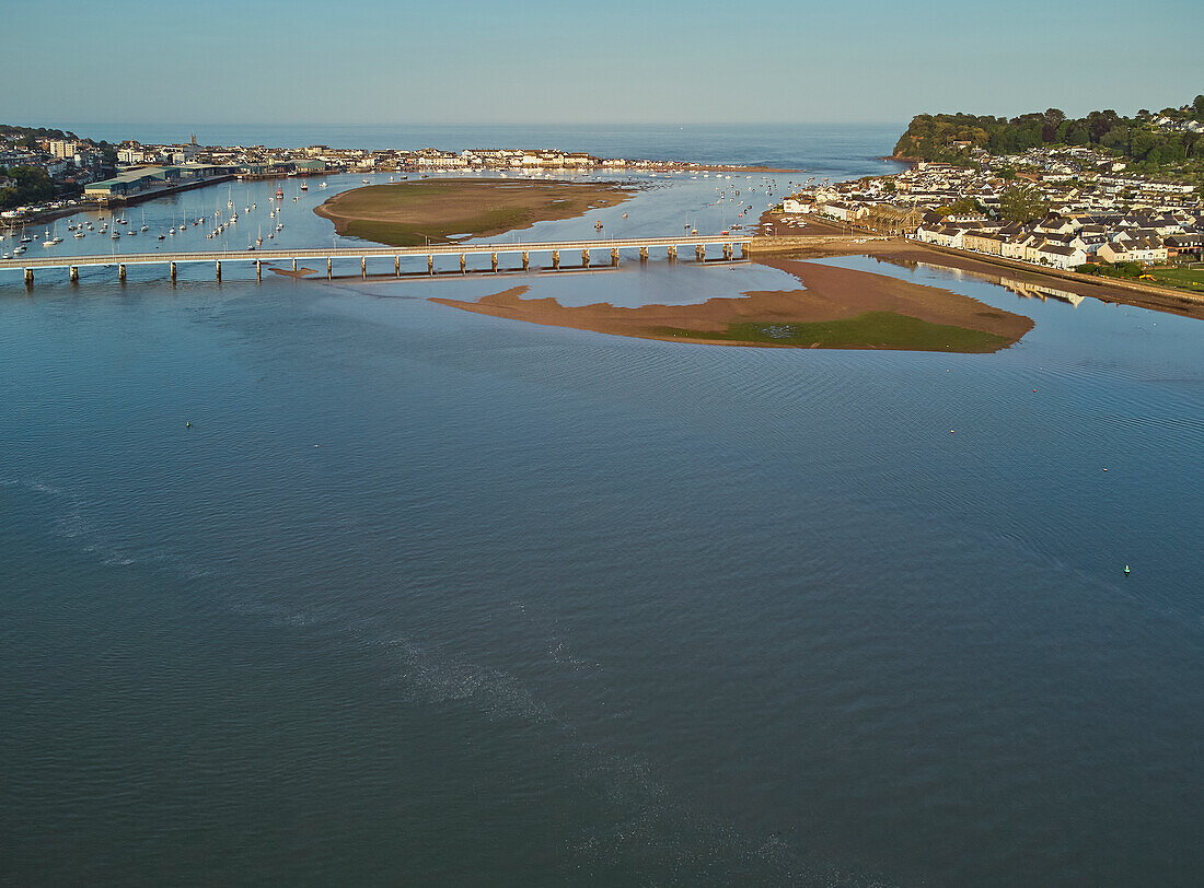 An evening view of the harbour and mouth of the River Teign, plus Shaldon Bridge, with Teignmouth on the left and Shaldon on the right, on the south coast of Devon, England, United Kingdom, Europe\n