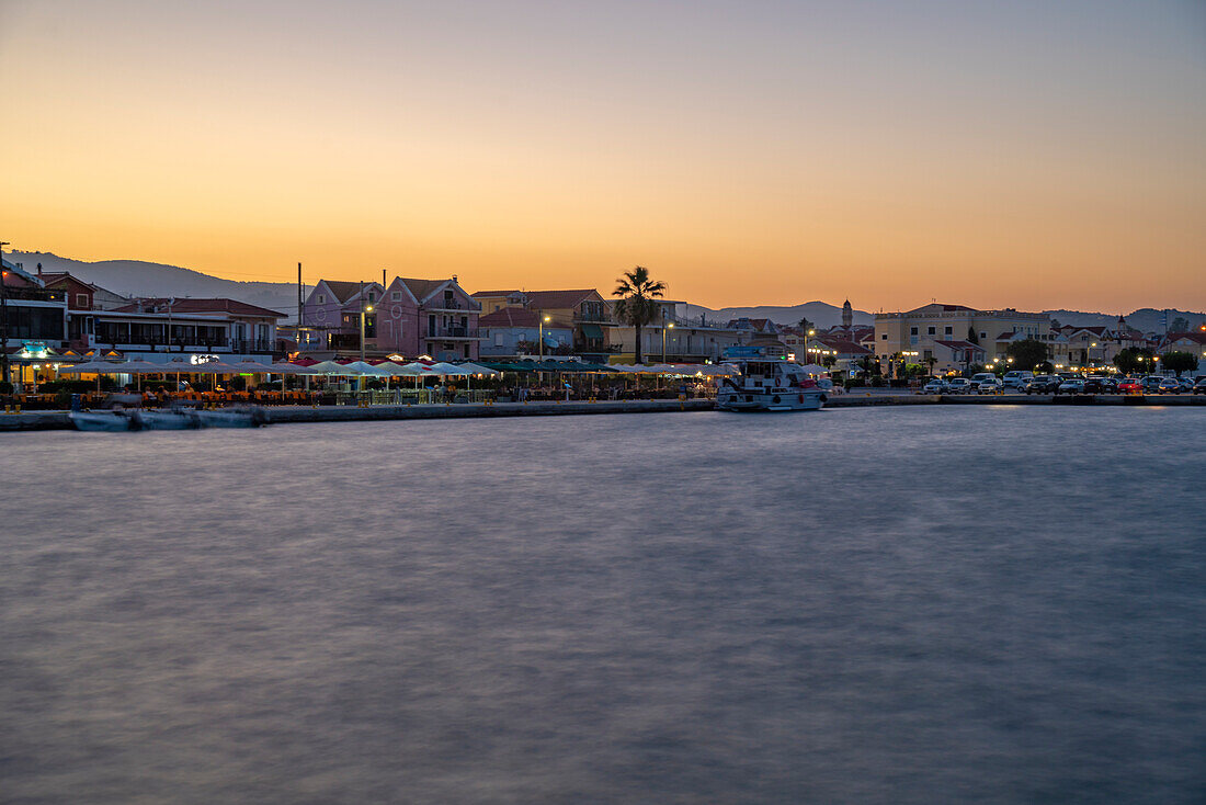 View of town skyline from the harbour at dusk, Lixouri, Kefalonia, Ionian Islands, Greek Islands, Greece, Europe\n