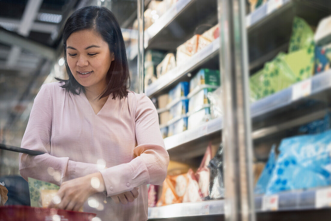 Young woman shopping during inflation in supermarket\n