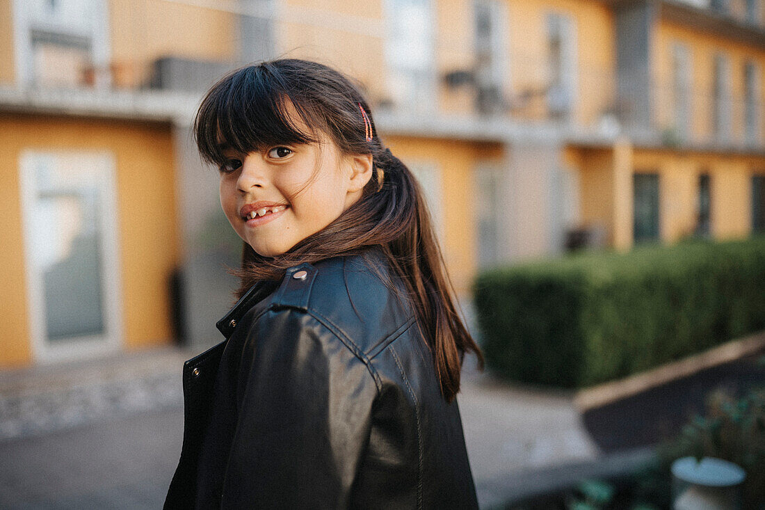 Portrait eines glücklich lächelnden Mädchens in Lederjacke