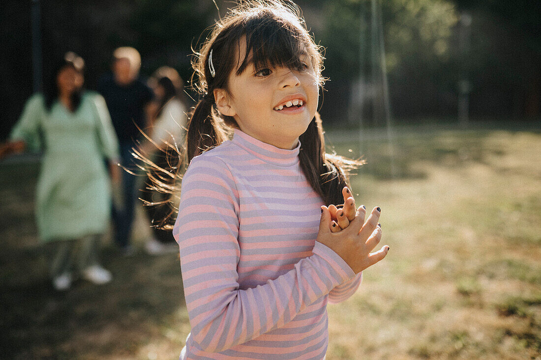 Happy smiling girl having fun in park\n