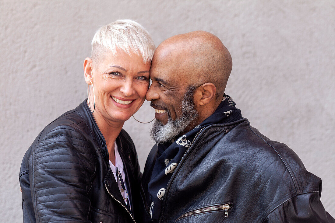 Portrait of cool mature biker couple in leather clothes\n