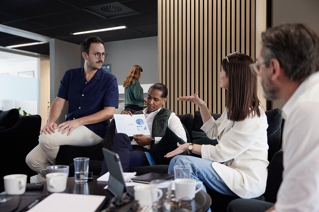 Group of business people having meeting in lobby\n