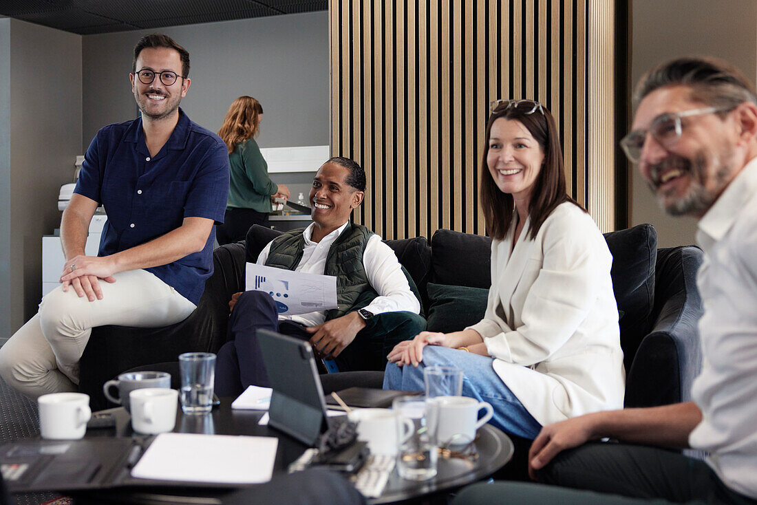 Group of business people having meeting in lobby\n