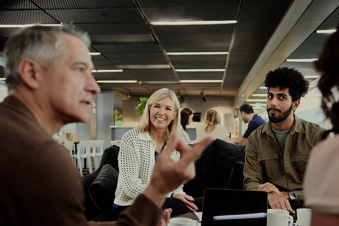 Group of business people having meeting in lobby\n