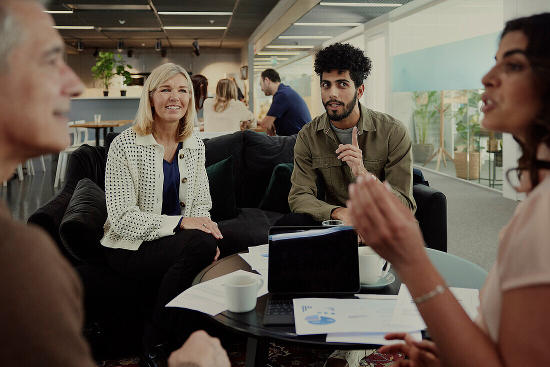 Group of business people having meeting in lobby\n