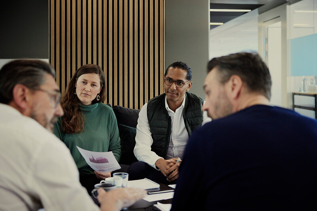 Group of business people having meeting in lobby\n