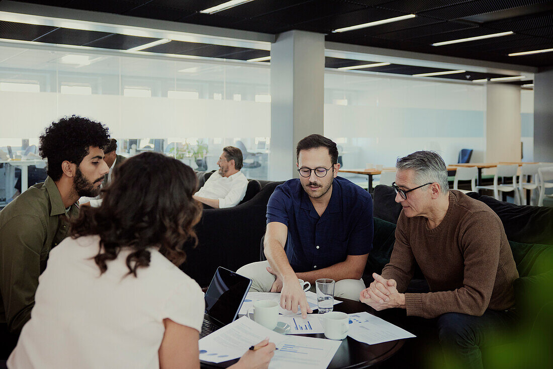 Group of business people having meeting in lobby\n