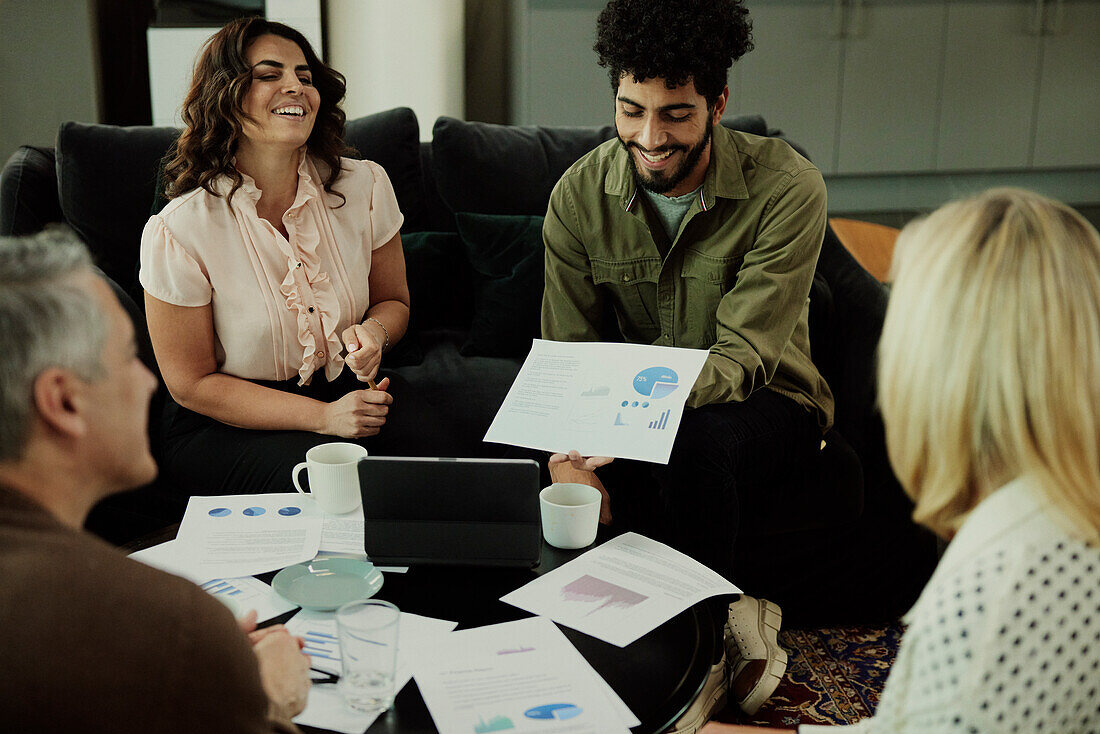 Group of business people having meeting in lobby\n