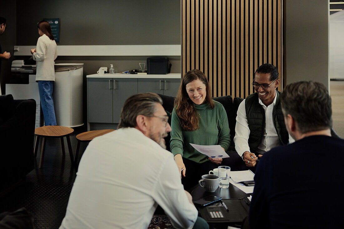 Group of business people having meeting in lobby\n