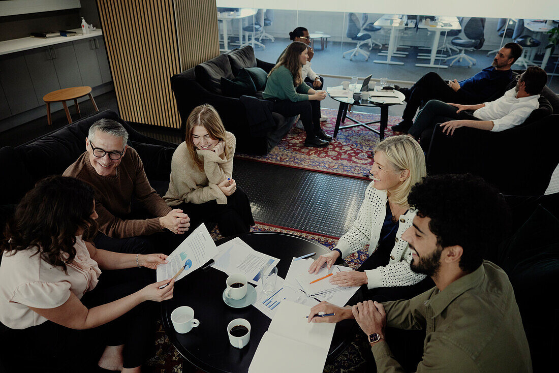 Group of business people having meeting in lobby\n