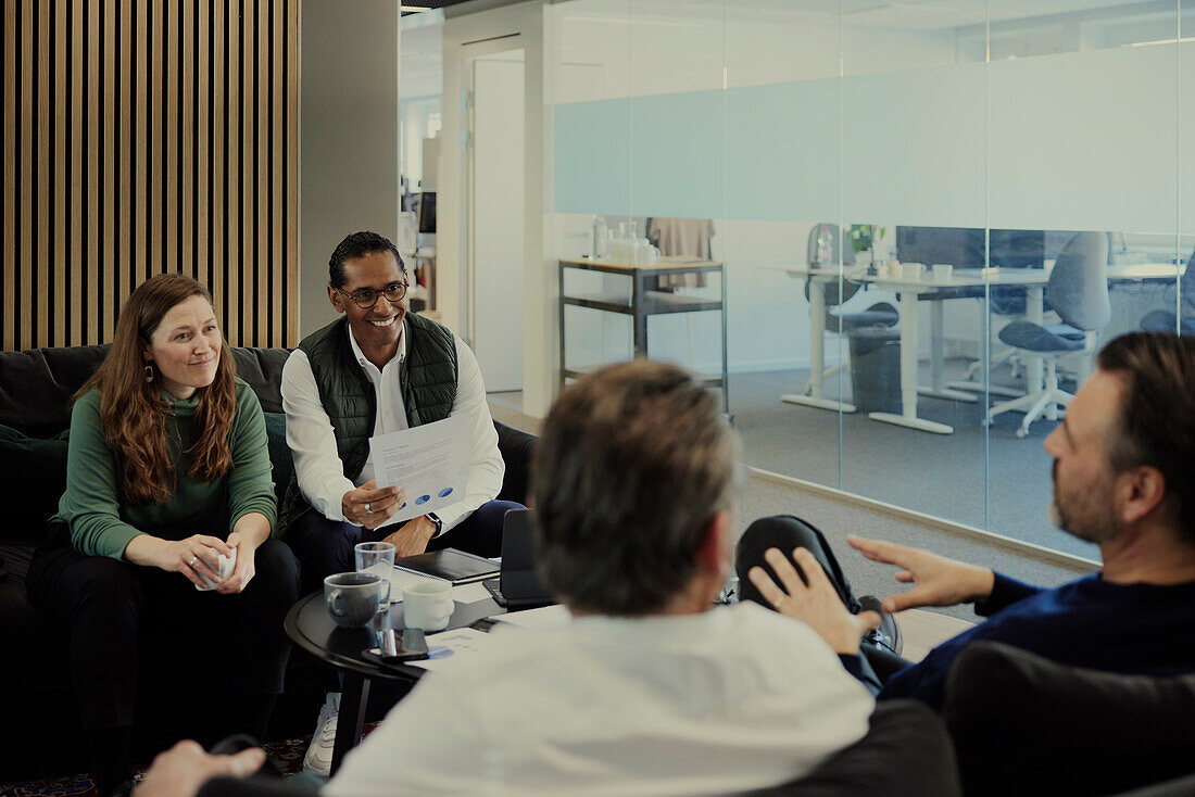 Group of business people having meeting in lobby\n