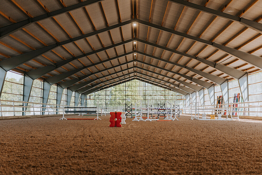 View of empty indoor riding paddock\n