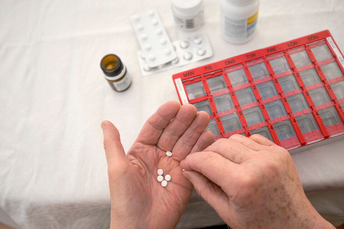 Close-up of person taking various medications\n