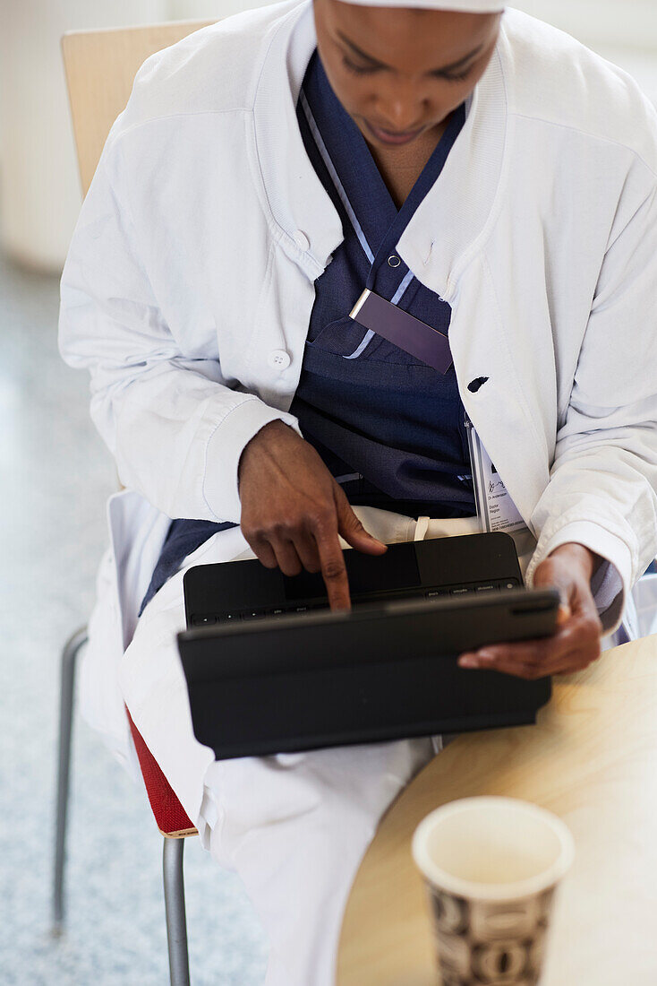 High angle view of female doctor using digital tablet\n