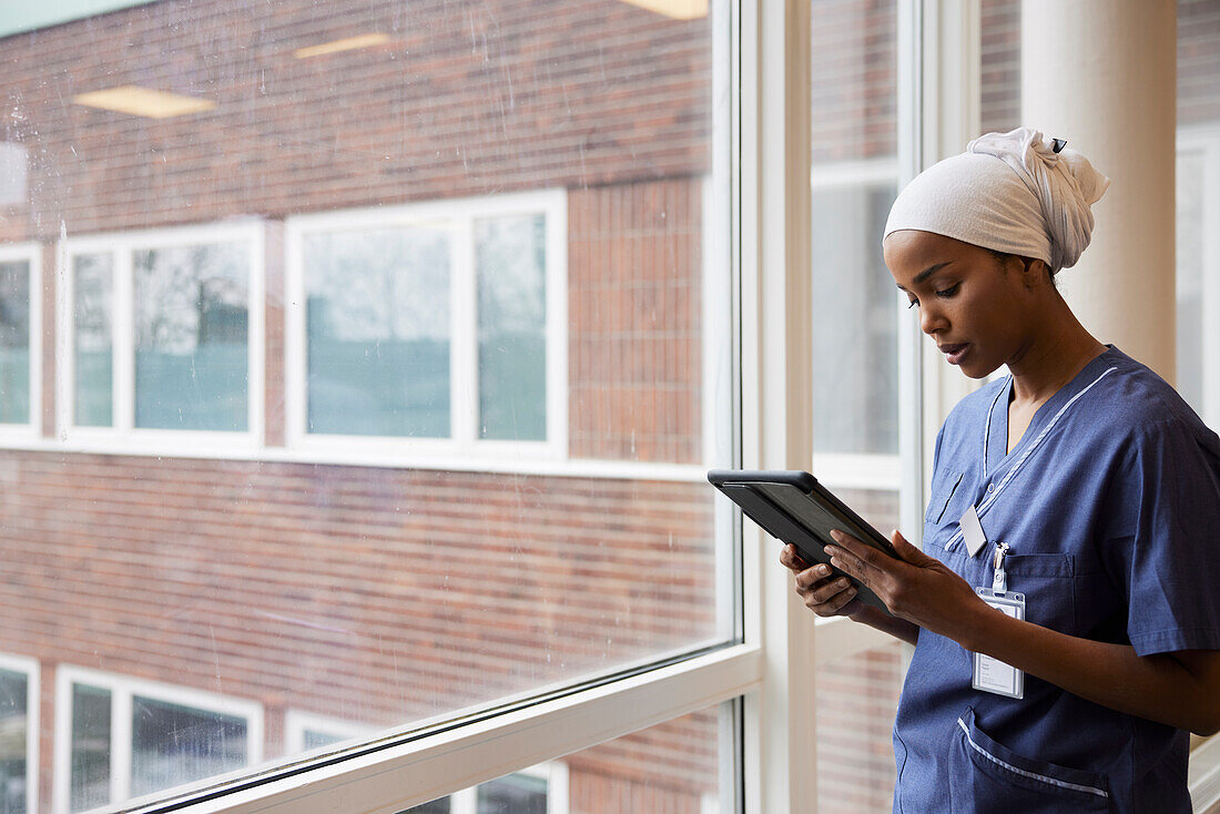 Young female doctor using tablet at work\n