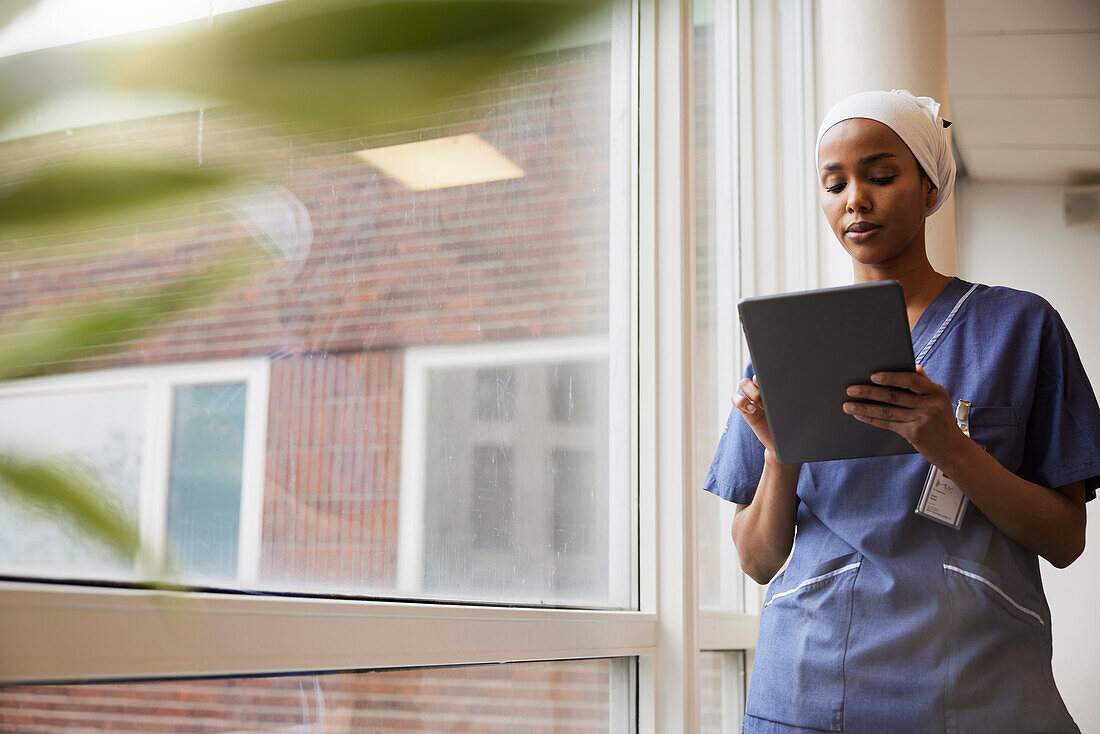 Young female doctor using tablet at work\n