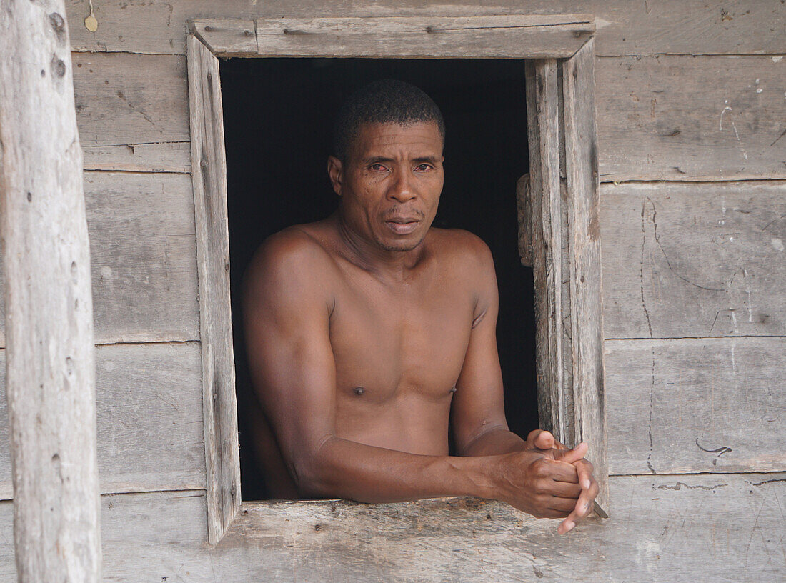 A man at the window of his house in the town of Beté, located in the department of Chocó in Colombia.\n