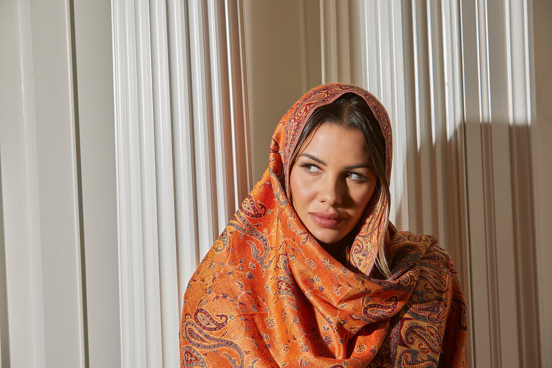 Portrait of woman wrapped in shawl\n