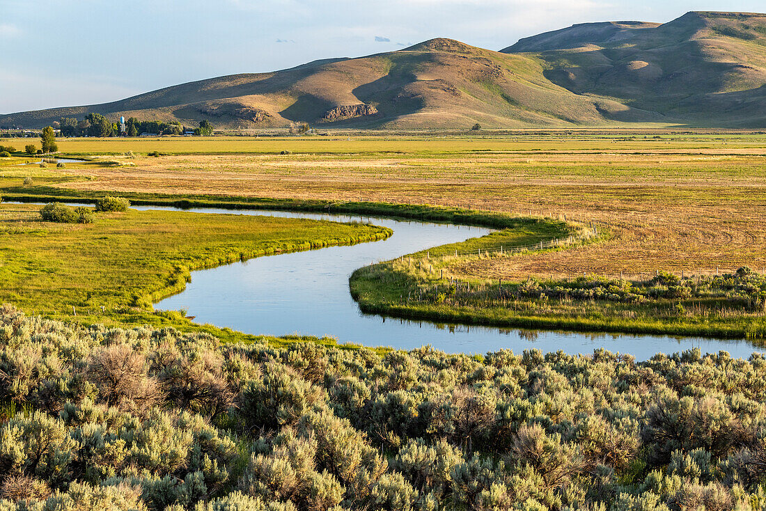 USA, Idaho, Bellevue, Silver Creek stream flowing through farmland\n