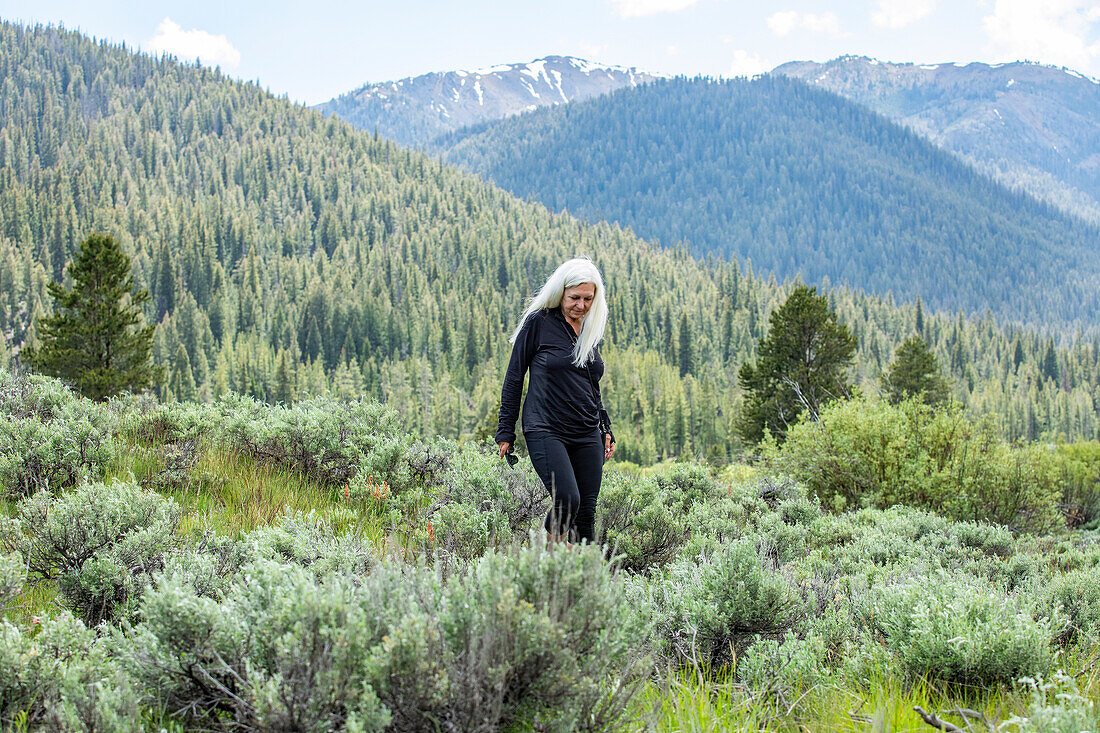 USA, Idaho, Sun Valley, Senior woman hiking in mountains\n