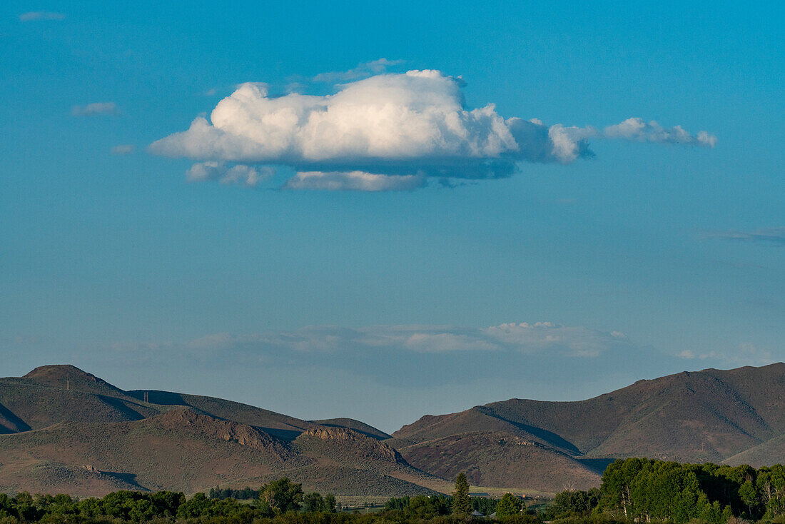 USA, Idaho, Bellevue, Cloud floating over foothills on sunny day\n