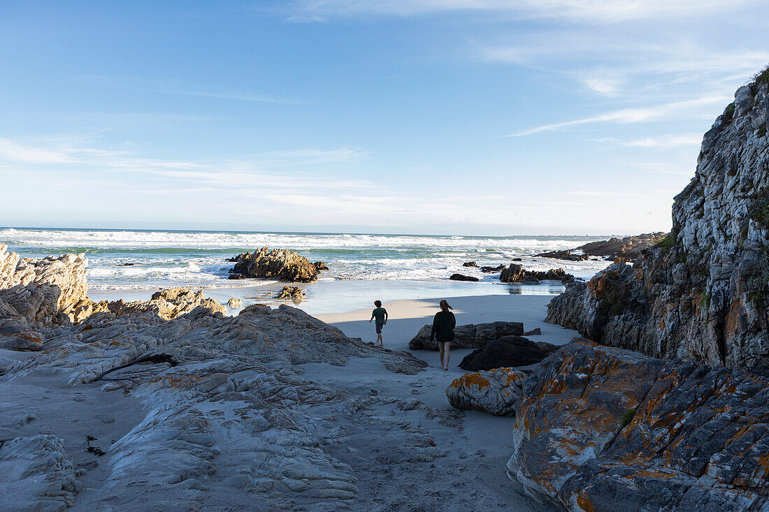 South Africa, Hermanus, Brother (10-11) and sister (16-17) exploring rocky coastline in Voelklip Beach\n