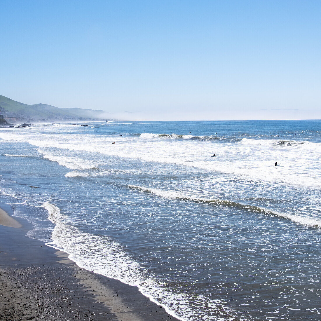 USA, California, Cayucos, Cayucos State Beach, Surfers in sea \n