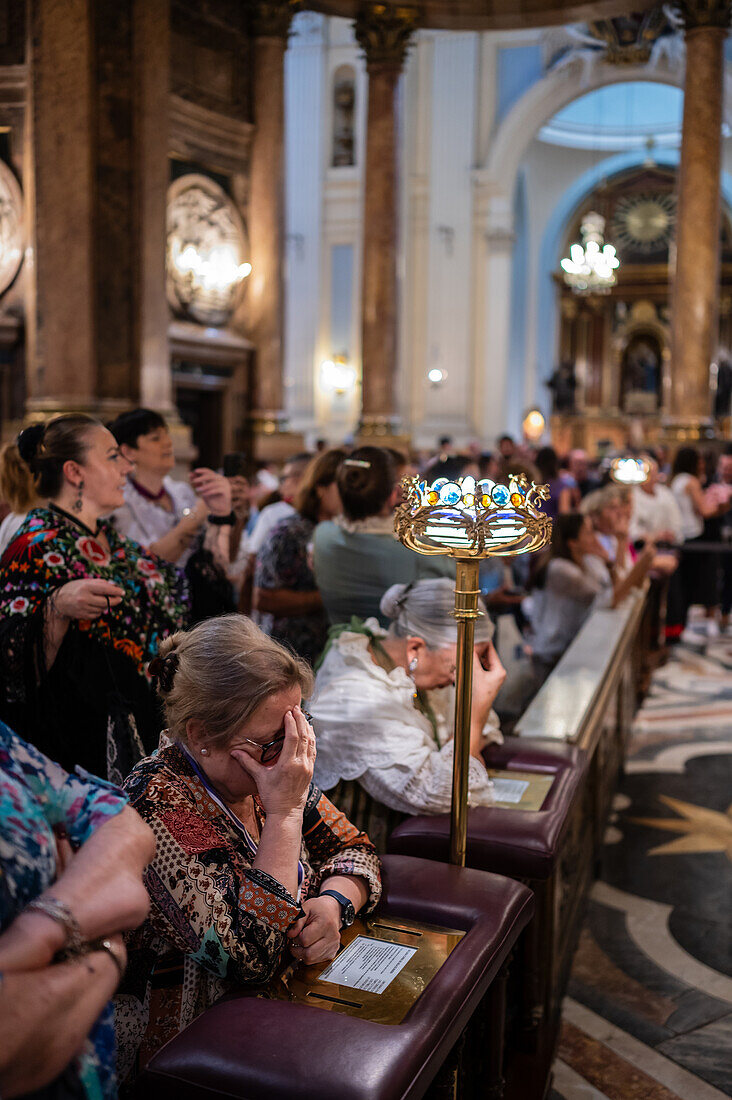 Believers inside the Cathedral-Basilica of Our Lady of the Pillar during The Offering of Flowers to the Virgen del Pilar, the most important and popular event of the Fiestas del Pilar held on Hispanic Day, Zaragoza, Spain\n