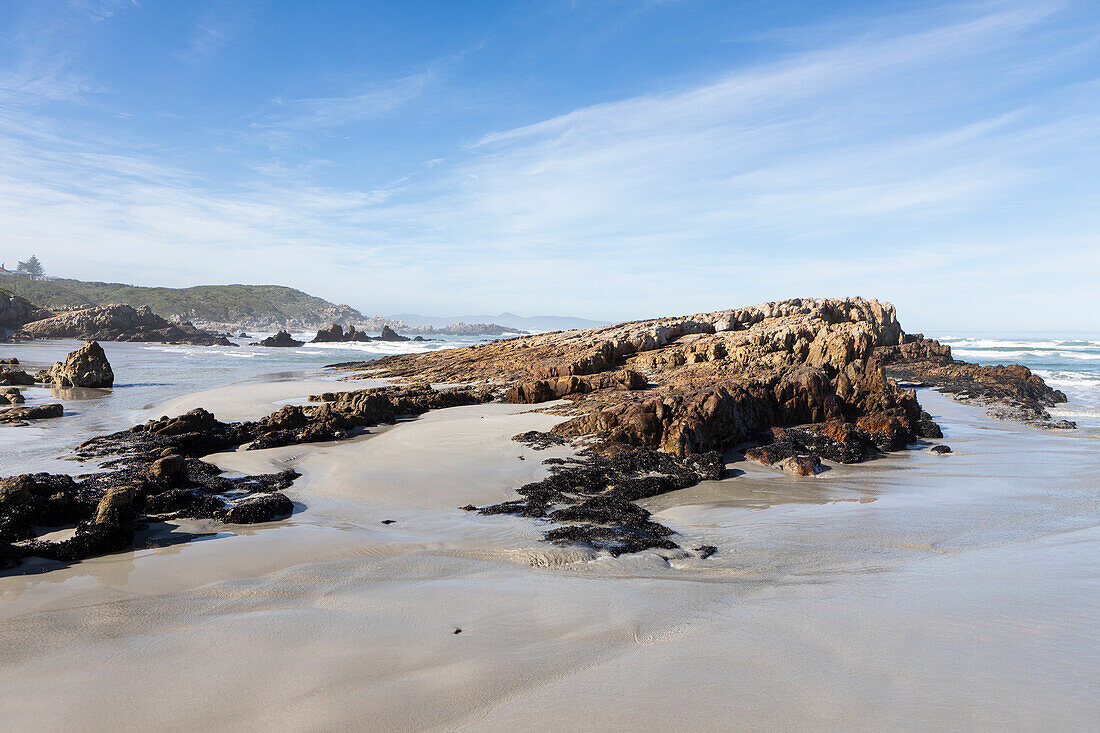 South Africa, Hermanus, Rocky coastline in Kammabaai Beach on sunny day\n