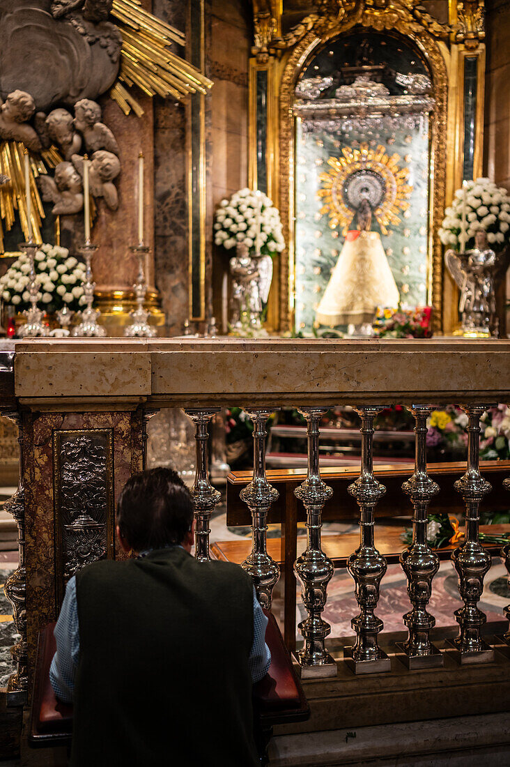 Believers inside the Cathedral-Basilica of Our Lady of the Pillar during The Offering of Flowers to the Virgen del Pilar, the most important and popular event of the Fiestas del Pilar held on Hispanic Day, Zaragoza, Spain\n