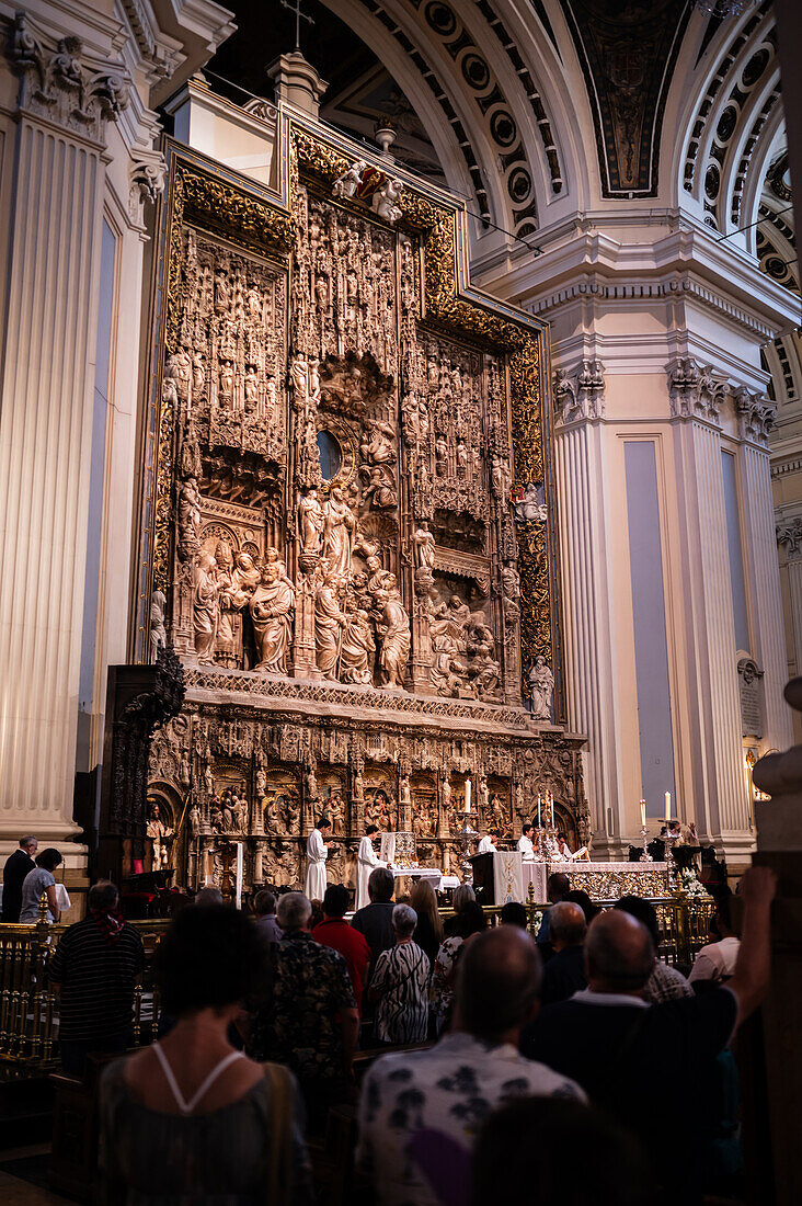 Believers inside the Cathedral-Basilica of Our Lady of the Pillar during The Offering of Flowers to the Virgen del Pilar, the most important and popular event of the Fiestas del Pilar held on Hispanic Day, Zaragoza, Spain\n