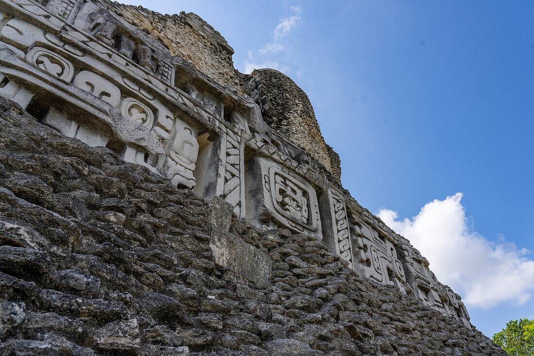The west frieze on El Castillo or Structure A-6 in the Mayan ruins of the Xunantunich Archeological Reserve in Belize. The center figure is identified as Kawil, an ancestral deity.\n