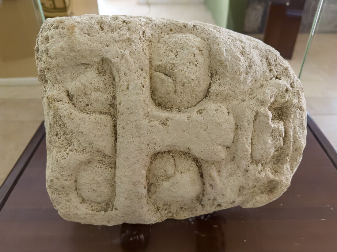 A carved limestone sculpture of Kinich Ahau, the Mayan sun god, in the museum in the Xunantunich Archeological Reserve in Belize.\n