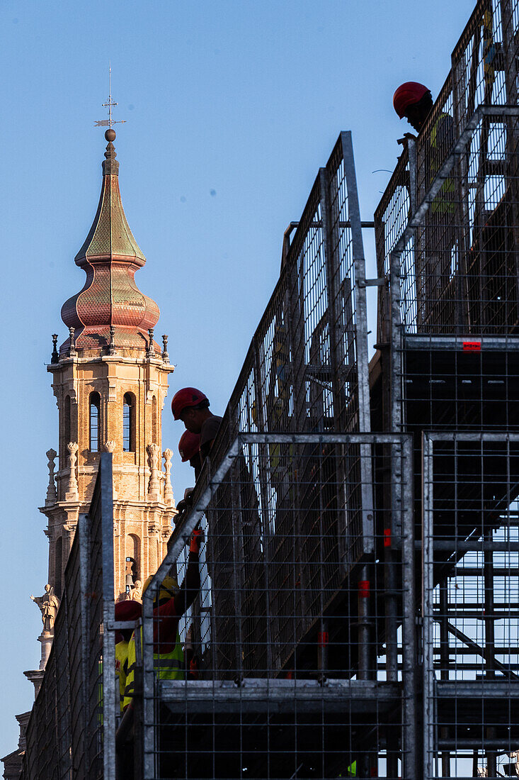 Workers preparing the platform for The Offering of Flowers to the Virgen del Pilar, the most important and popular event of the Fiestas del Pilar held on Hispanic Day, Zaragoza, Spain\n