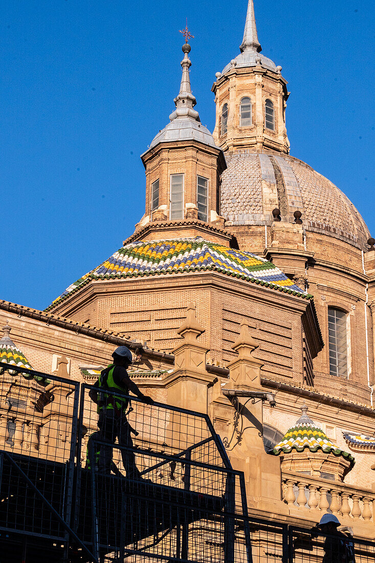 Workers preparing the platform for The Offering of Flowers to the Virgen del Pilar, the most important and popular event of the Fiestas del Pilar held on Hispanic Day, Zaragoza, Spain\n