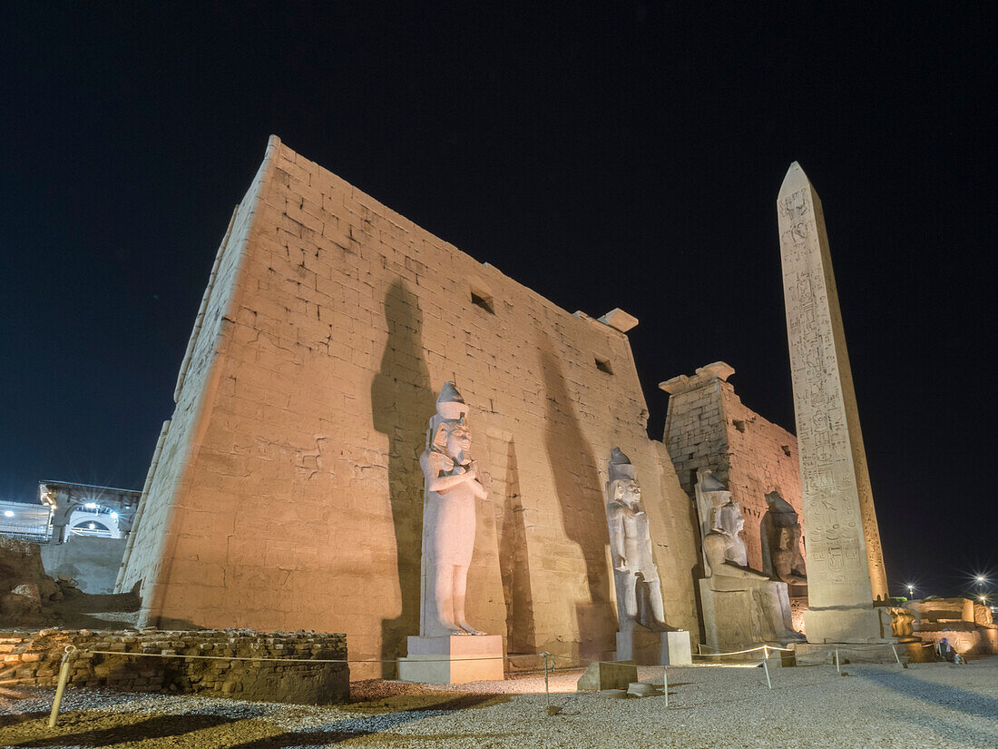 The Luxor Temple at night, a large Ancient Egyptian temple complex constructed approximately 1400 BCE, Luxor, UNESCO World Heritage Site, Luxor, Thebes, Egypt, North Africa, Africa\n