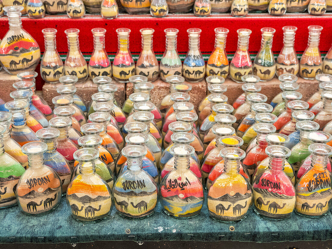 Colourful souvenir bottles of sand for sale in the city of Jerash, Jordan, Middle East\n