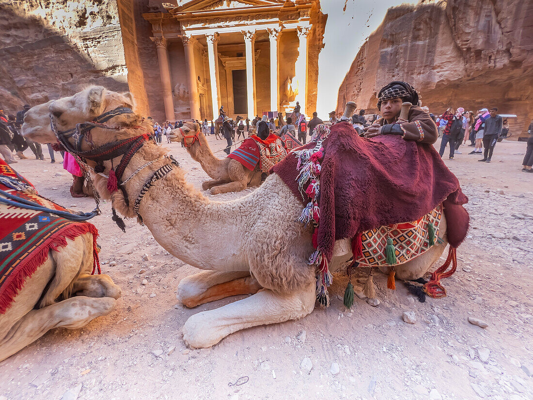 A boy with a camel, the Petra Treasury (Al-Khazneh), Petra Archaeological Park, UNESCO World Heritage Site, one of the New Seven Wonders of the World, Petra, Jordan, Middle East\n