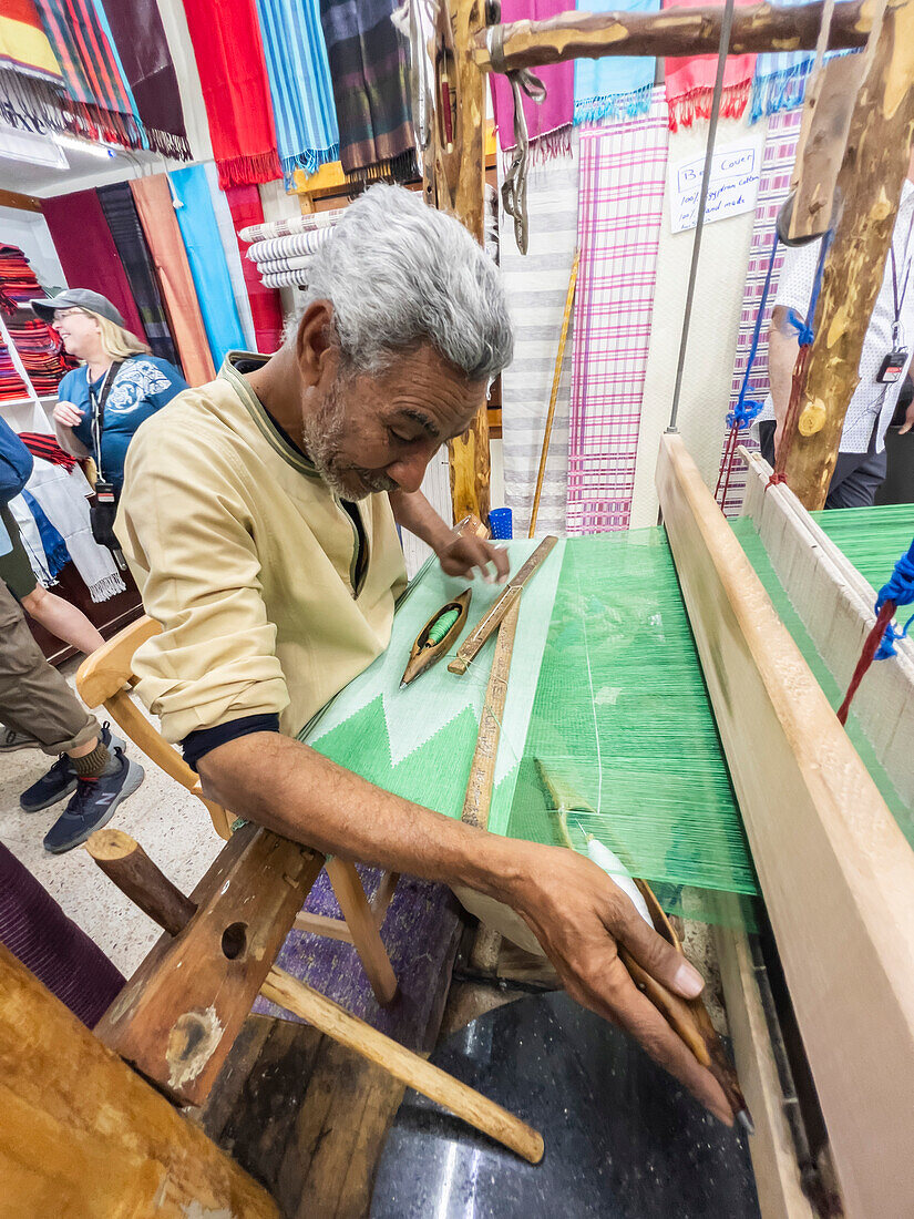 Egyptian man working on a loom in a shop at the unfinished obelisk in Aswan, Egypt, North Africa, Africa\n