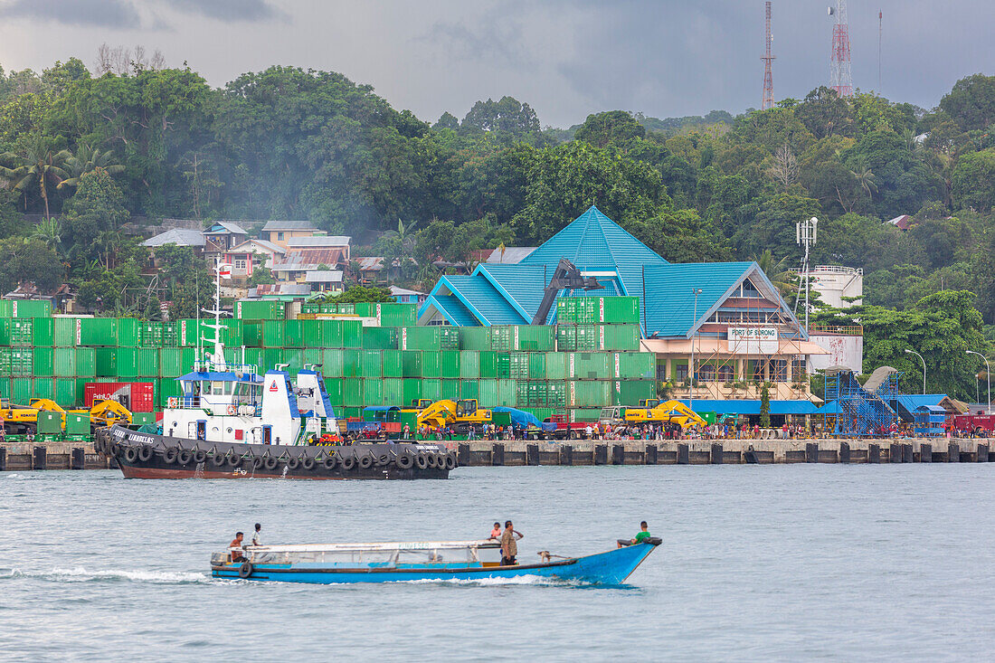 Boat and containers in the harbor in the city of Sorong, the largest city and the capital of the Indonesian province of Southwest Papua, Indonesia, Southeast Asia, Asia\n