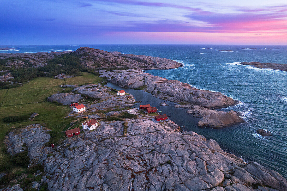 Aerial view of the scenic landscape of granite rocks with isolated houses and red cottages along the shore, Ramsvik island, Bohuslan, Vastra Gotaland, West Sweden, Sweden, Scandinavia, Europe\n