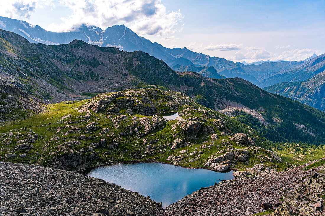 Beautiful nameless mountain lake view from Cima Verosso on the border of Italy and Switzerland, Zwischbergen, Valais, Switzerland, Europe\n