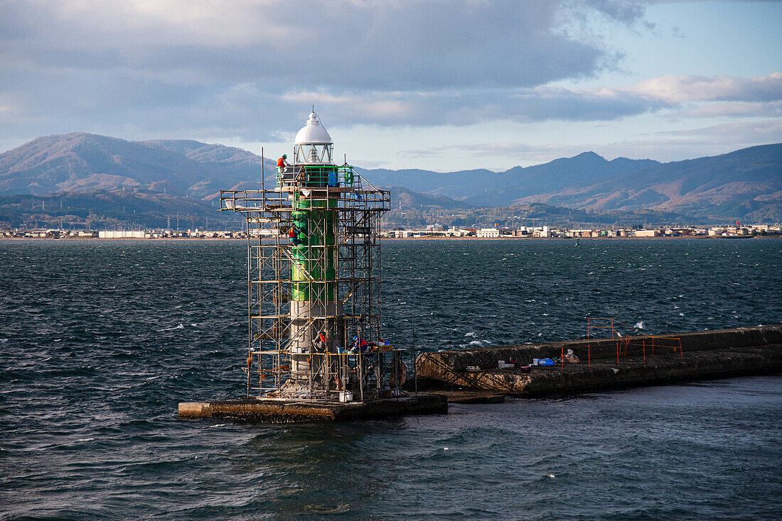 Green lighthouse being constructed in the sea of Hakodate, Hokkaido, northern Japan, Asia\n