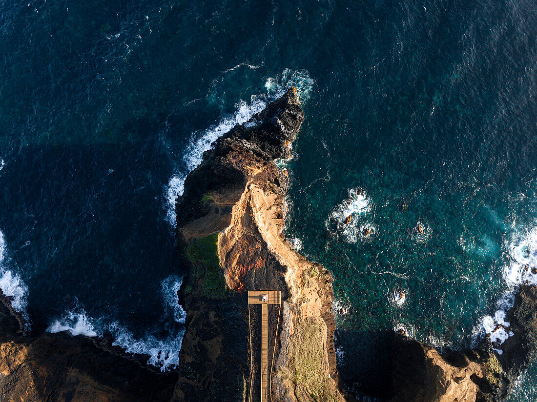 Aerial view of the coasts and cliffs of the island of Sao Miguel over the lighthouse of Farolim dos Fenais da Ajuda, Azores Islands, Portugal, Atlantic, Europe\n