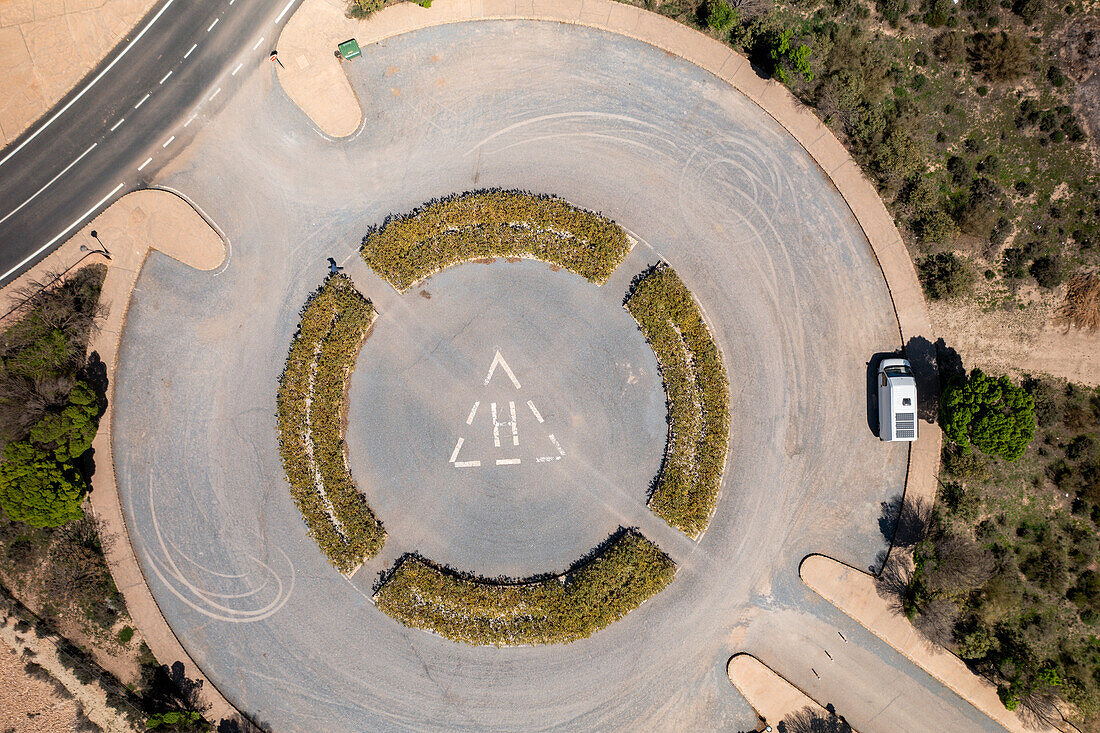 Drone aerial view of a helicopter landing parking on a desert like landscape at Francisco Abellan Dam, Granada, Andalusia, Spain, Europe\n