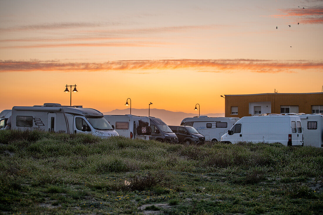 Wohnmobile und Wohnwagen auf einer Raststätte bei Sonnenuntergang, Andalusien, Spanien, Europa