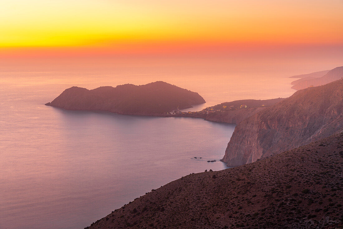 View of Assos, coastline, sea and hills at sunset, Kefalonia, Ionian Islands, Greek Islands, Greece, Europe\n